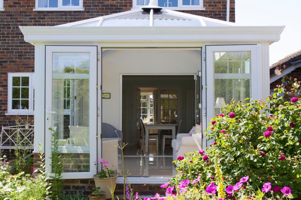 Upvc orangery extension with double doors opening out to the garden