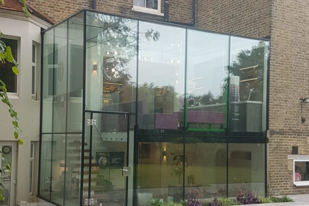 Double storey frameless glass extension