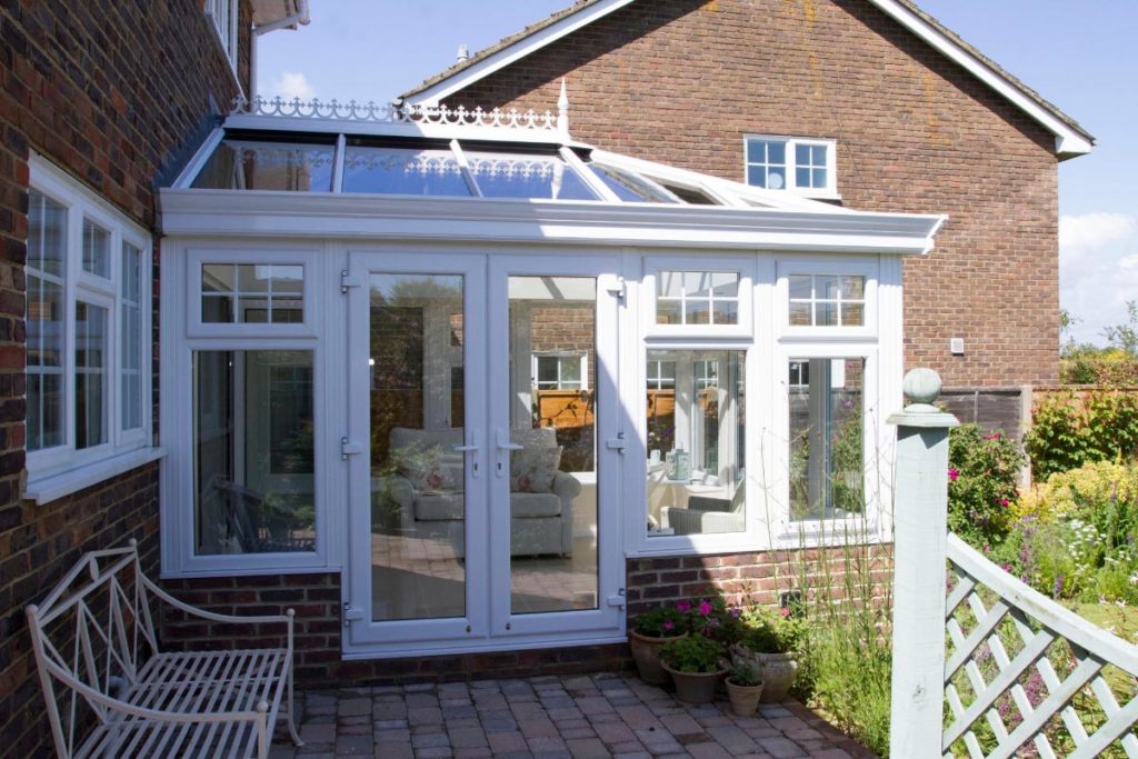 A luxury white uPVC orangery extends the living area out into the beautiful country garden
