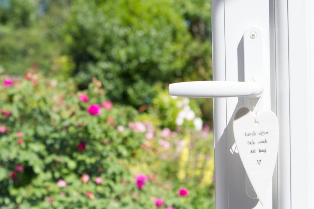 White uPVC doors open the orangery up to the garden