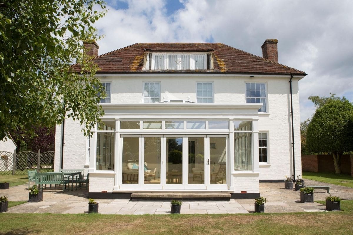 Luxurious white timber orangery extension on a larger Georgian country property
