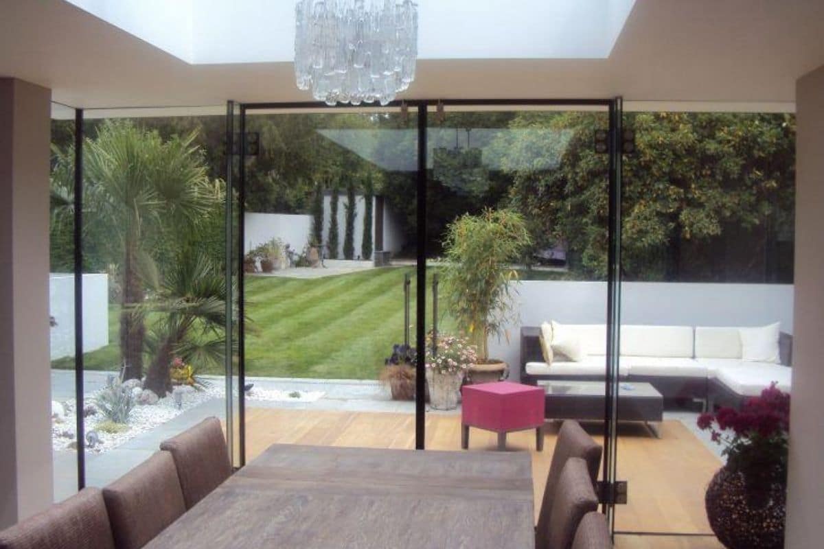 Orangery extension with structural frameless glass exterior wall
