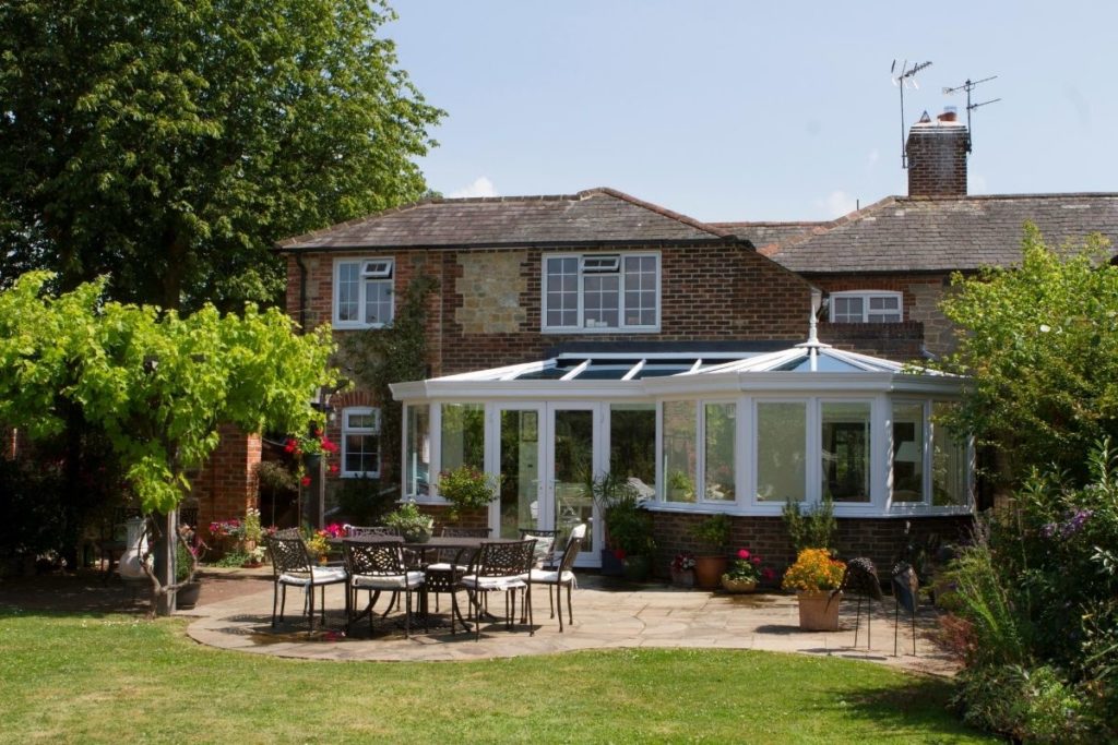 Large bespoke white uPVC orangery with brick dwarf walls