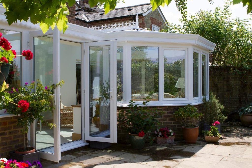 White framed uPVC orangery opening out with double doors onto the patio