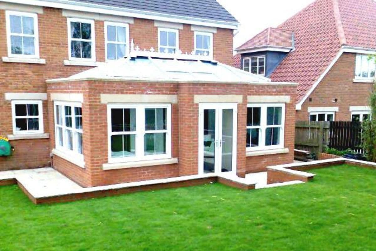 Brick orangery extension with white uPVC frames and lantern roof