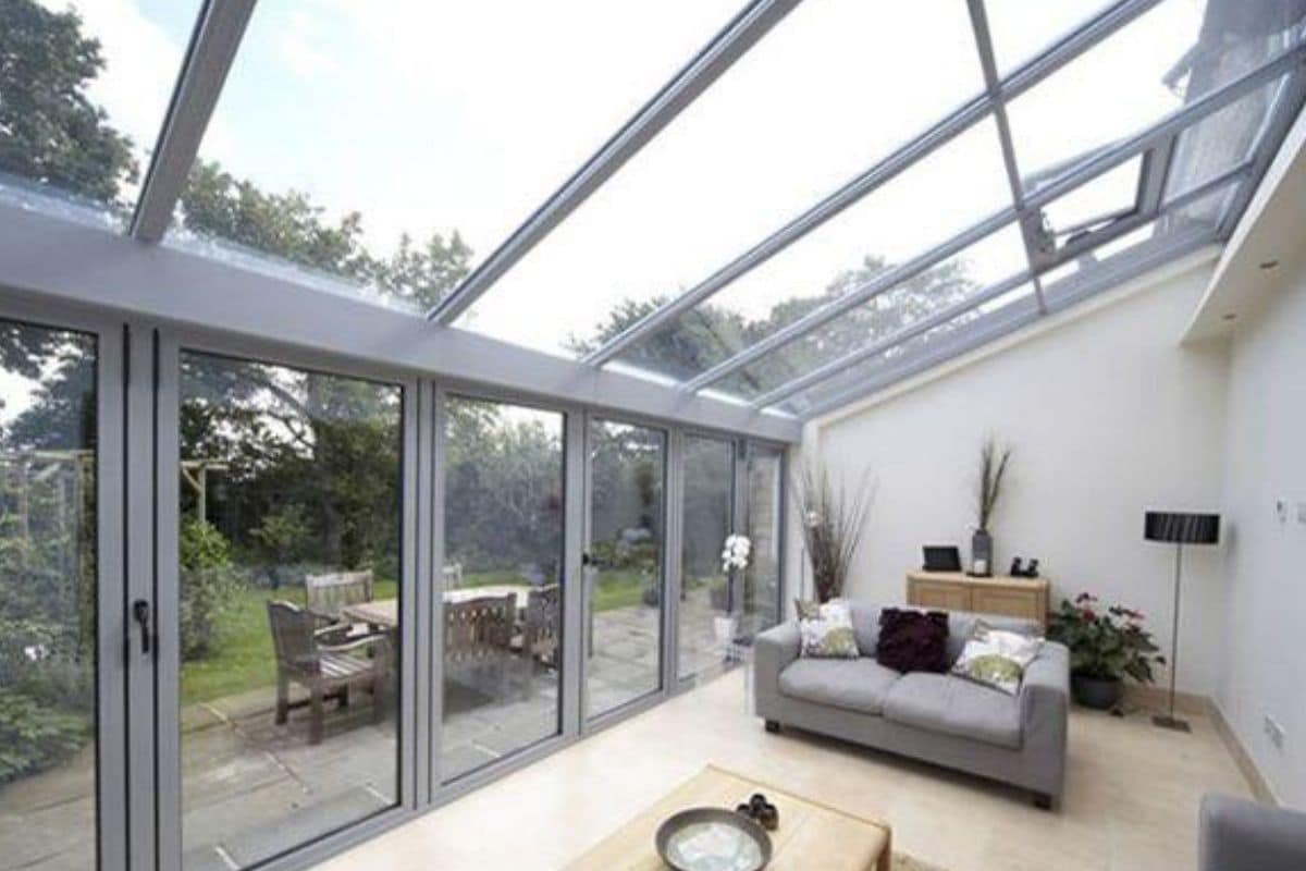 Modern grey aluminium lean-to conservatory extension used as a lounge