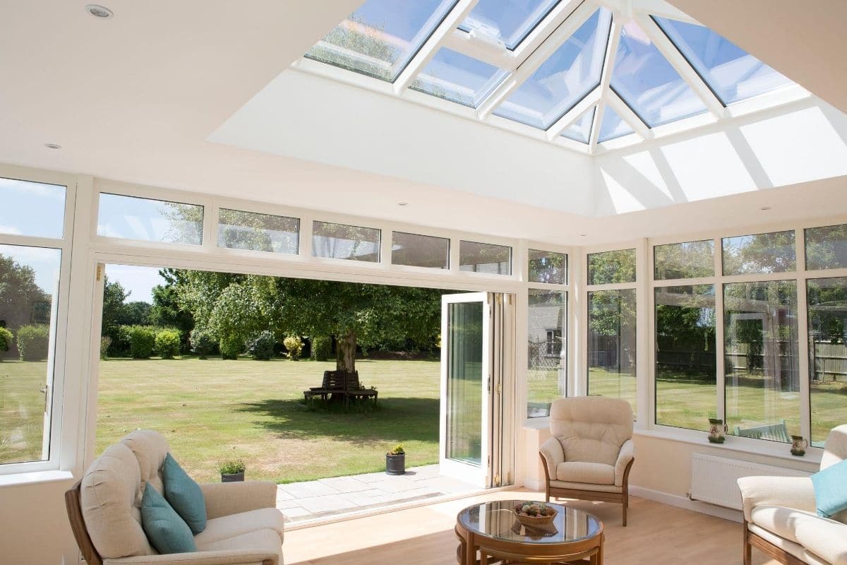 Inside a bright and spacious luxury timber orangery extension with large lantern roof