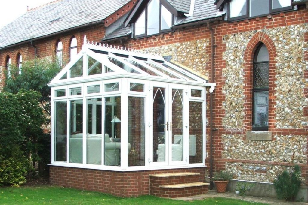 Small white uPVC conservatory with a gable roof