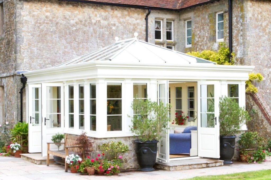 Beautiful traditional timber orangery with double aspect French doors opening to a country garden