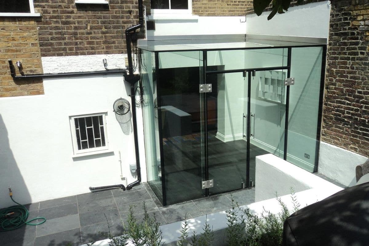 Modern glass box extension opens up the exterior of the property and brings light into the home