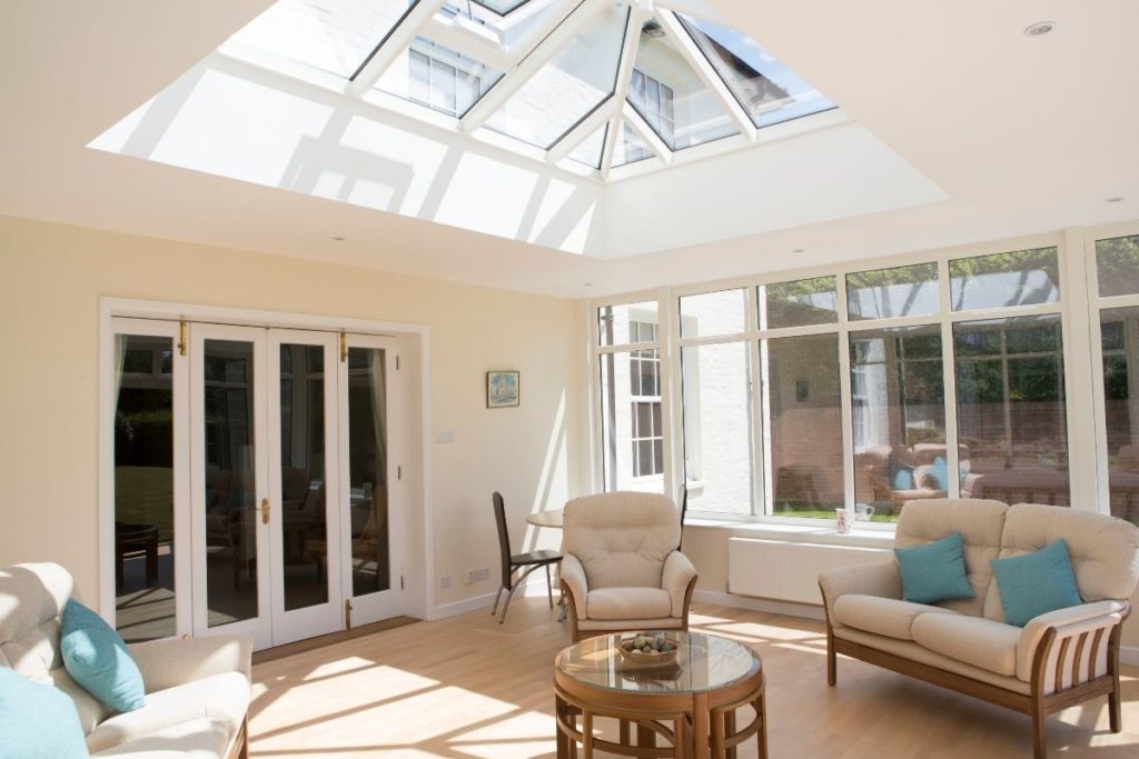 An orangery extension installed with concertina doors separating the glass room from the main home, keeping the heat in.