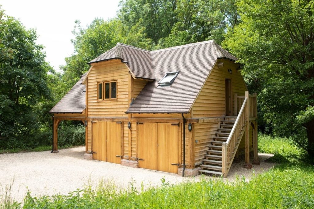 an oak double garage and car port with a self contained studio above it