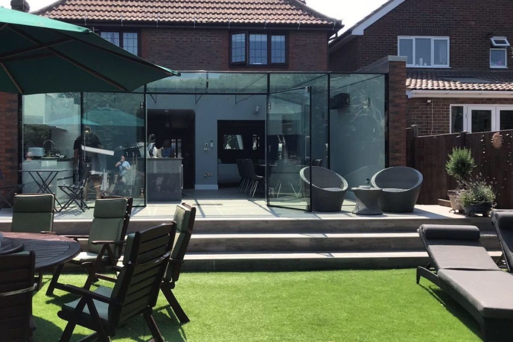 Frameless glass kitchen extension with the double doors open