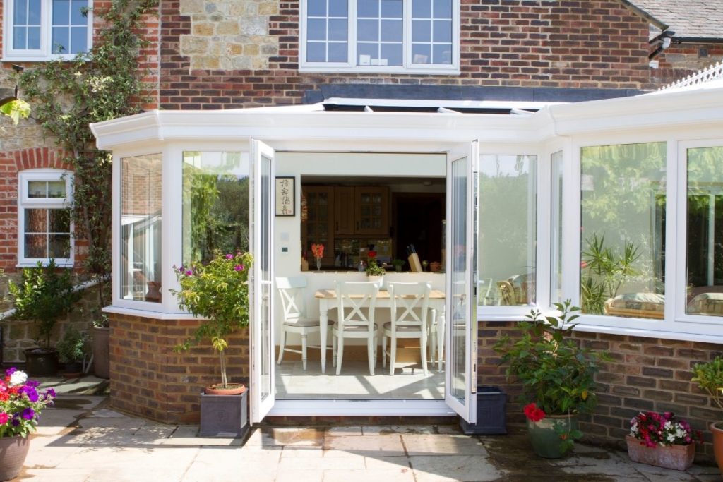 uPVC orangery extension with a cut-through from the dining area to the kitchen and an additional relaxing lounge area