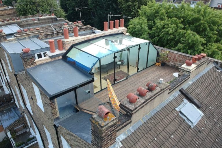 Small frameless glass rooftop sunroom