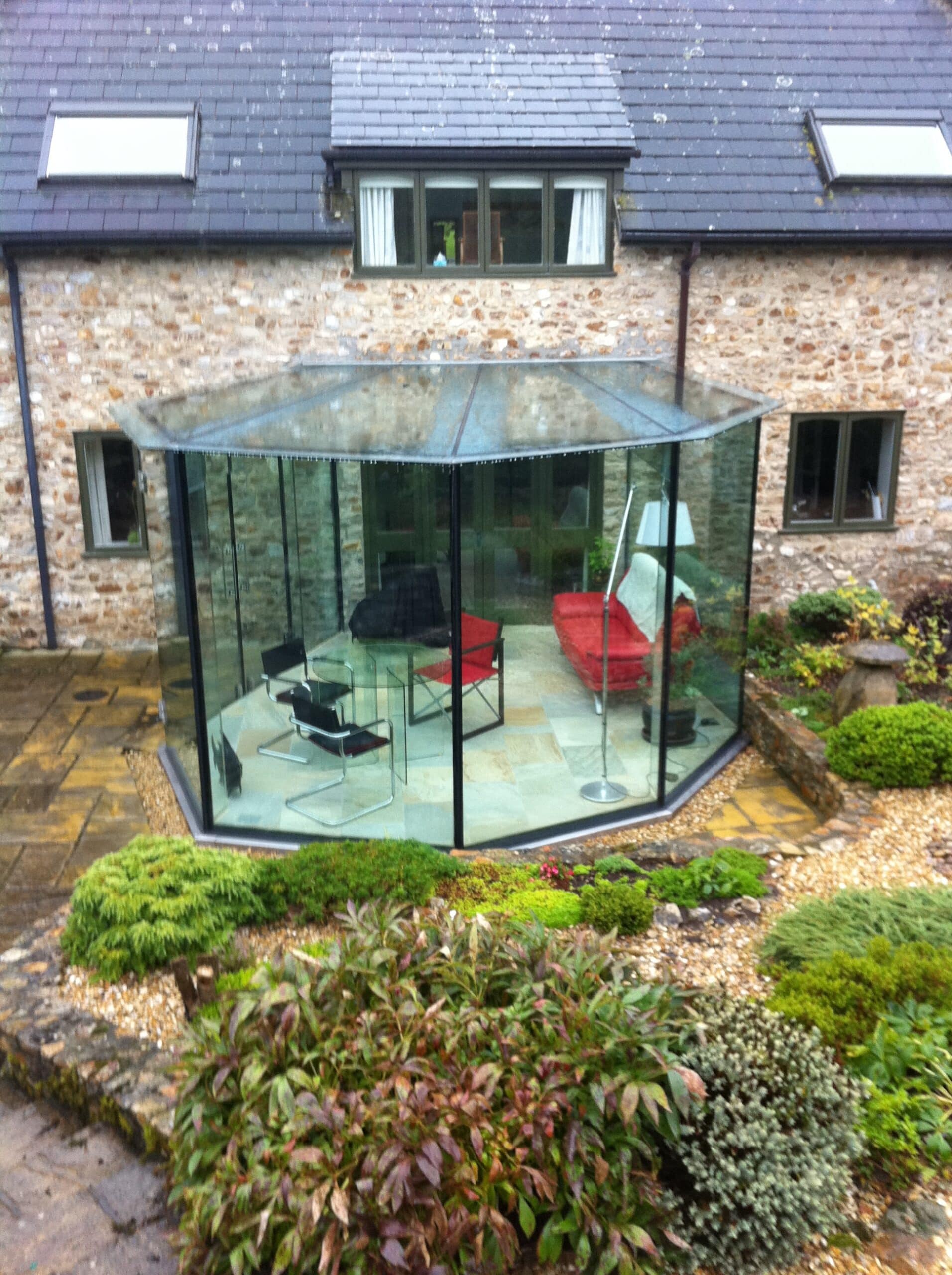 Octagonal glass garden room on a stone cottage