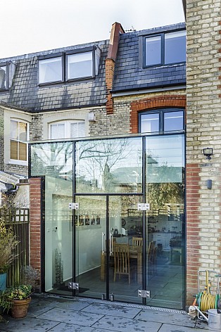 Frameless glass box extension on a terraced house